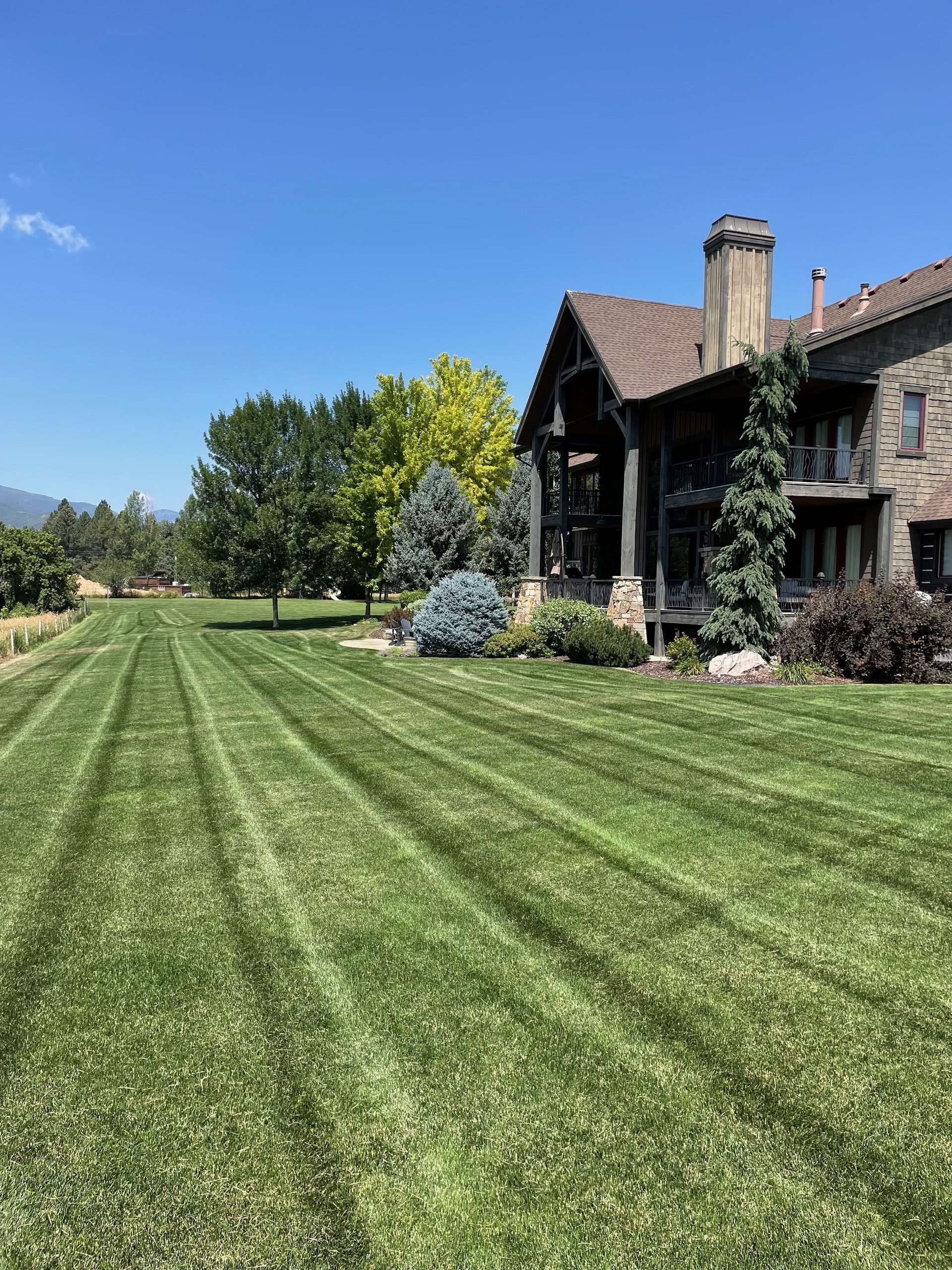 Mountain luxury home with manicured lawn and perfect mowing stripes — Ogden Valley